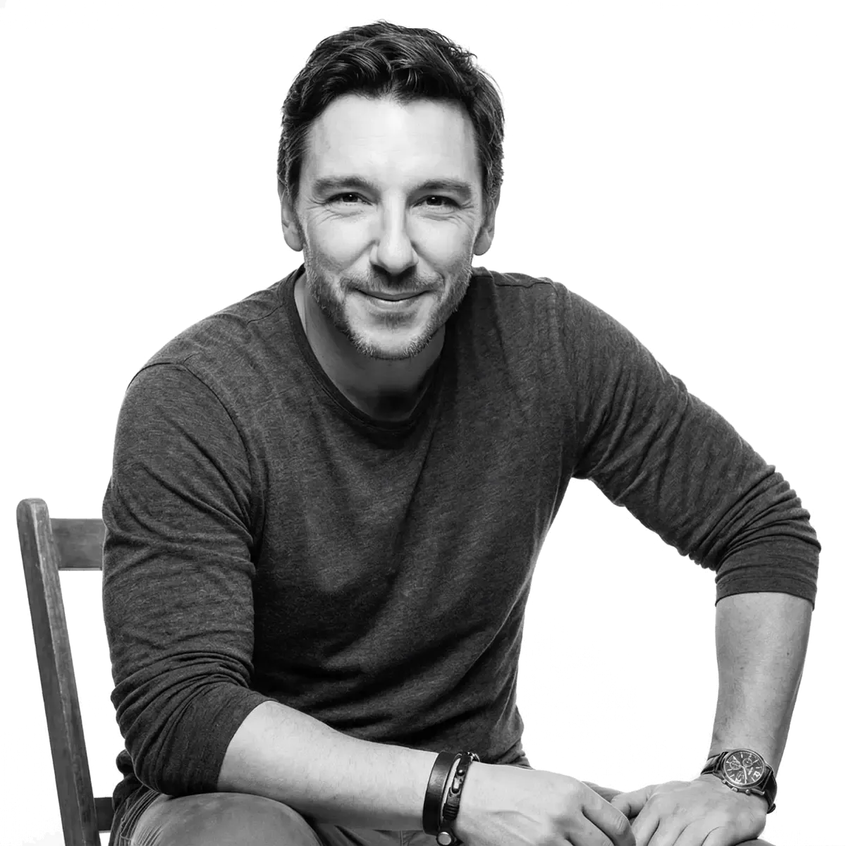 Chris Good, seated, in a black and white portrait